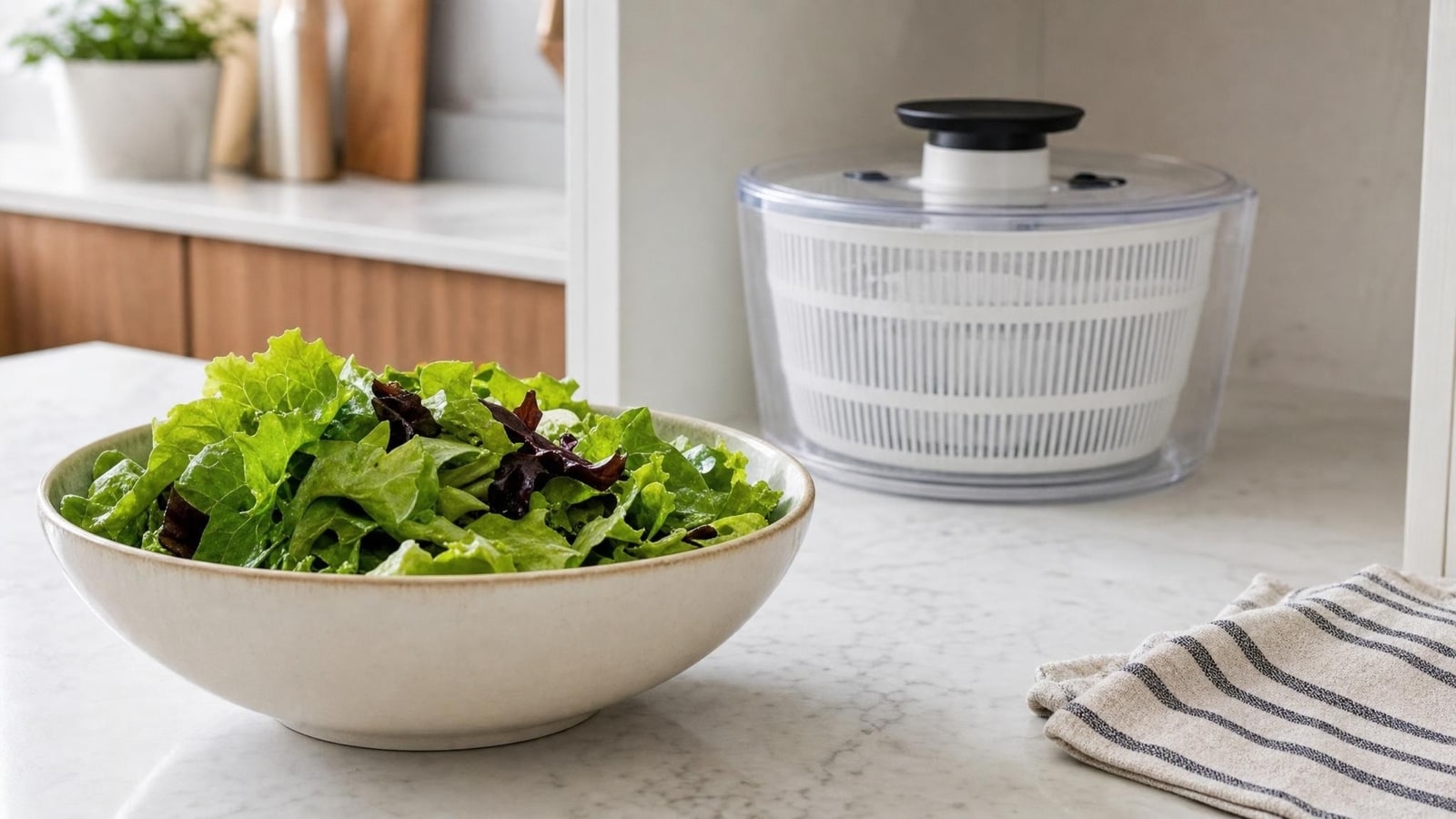 Dry leafy greens ready in a simple salad bowl with the cleaned generic spinner stored unobtrusively in a calm kitchen