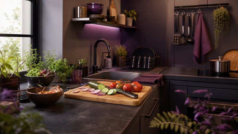 Organized small-kitchen preparation zone with vegetables, clear work surfaces, and compact tools